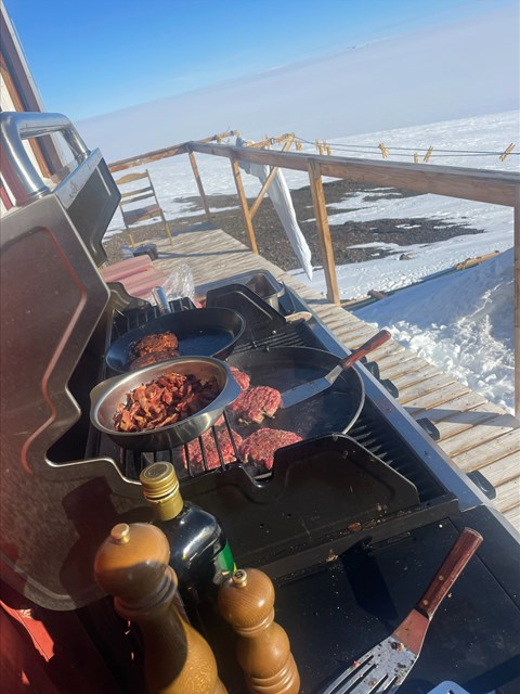 A grill where meat is cooked. In the background you can see the Antarctic expanses.
