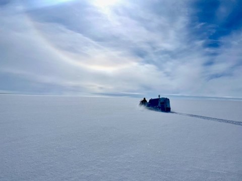 Snowmobile pulling an ark in Antarctica